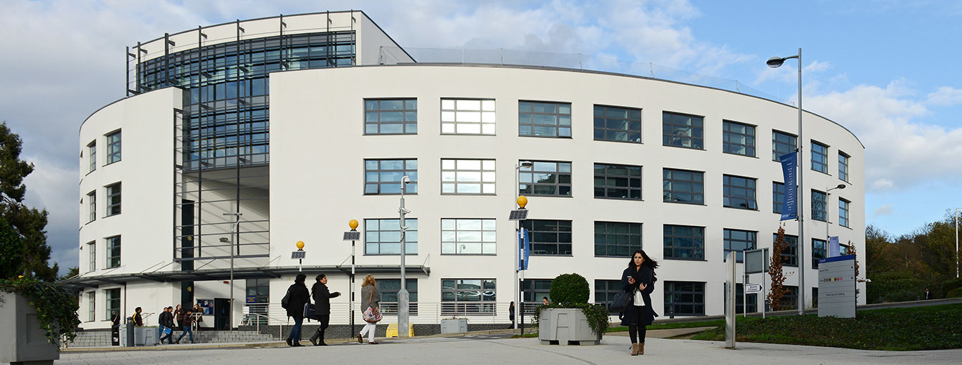 brunel university, a large white curved building